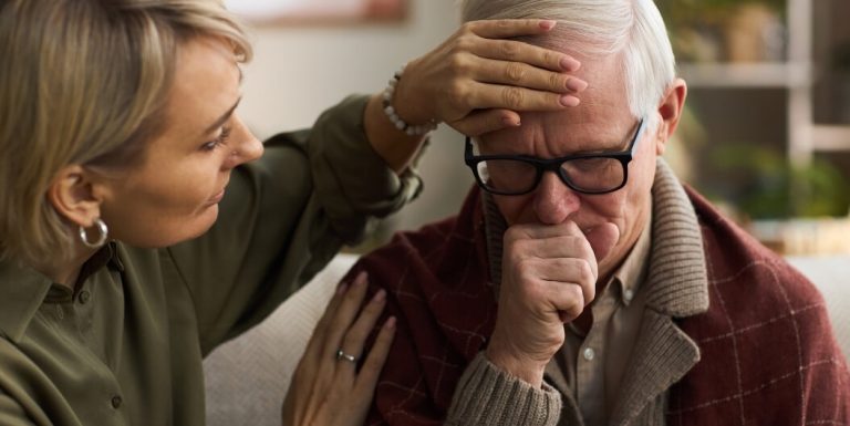 Woman Providing Emotional Support to Senior Man at Assisted Living Facility