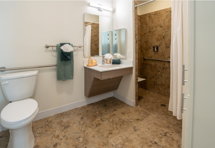 Accessible Bathroom With Grab Bars Walk In Shower and Vanity at Assisted Living Facility