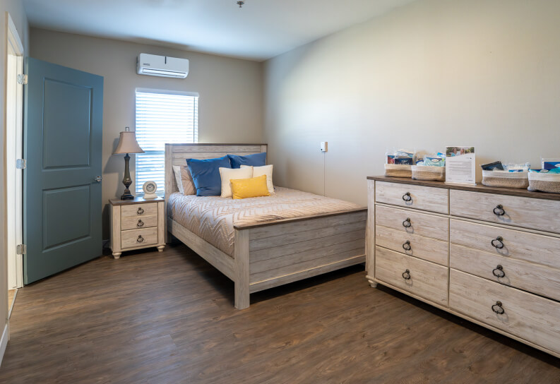 Resident Bedroom With Storage Dresser and Nightstand at Assisted Living Facility Resident Bedroom With Storage Dresser and Nightstand at Assisted Living Facility